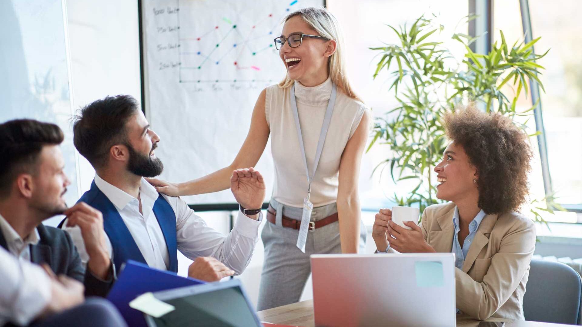 Coworkers laughing at meeting.