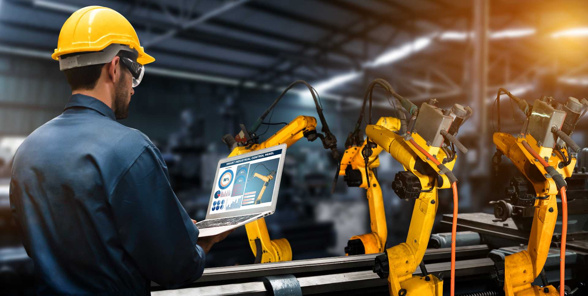 A factory overseeing his tablet and looking at the machinery.