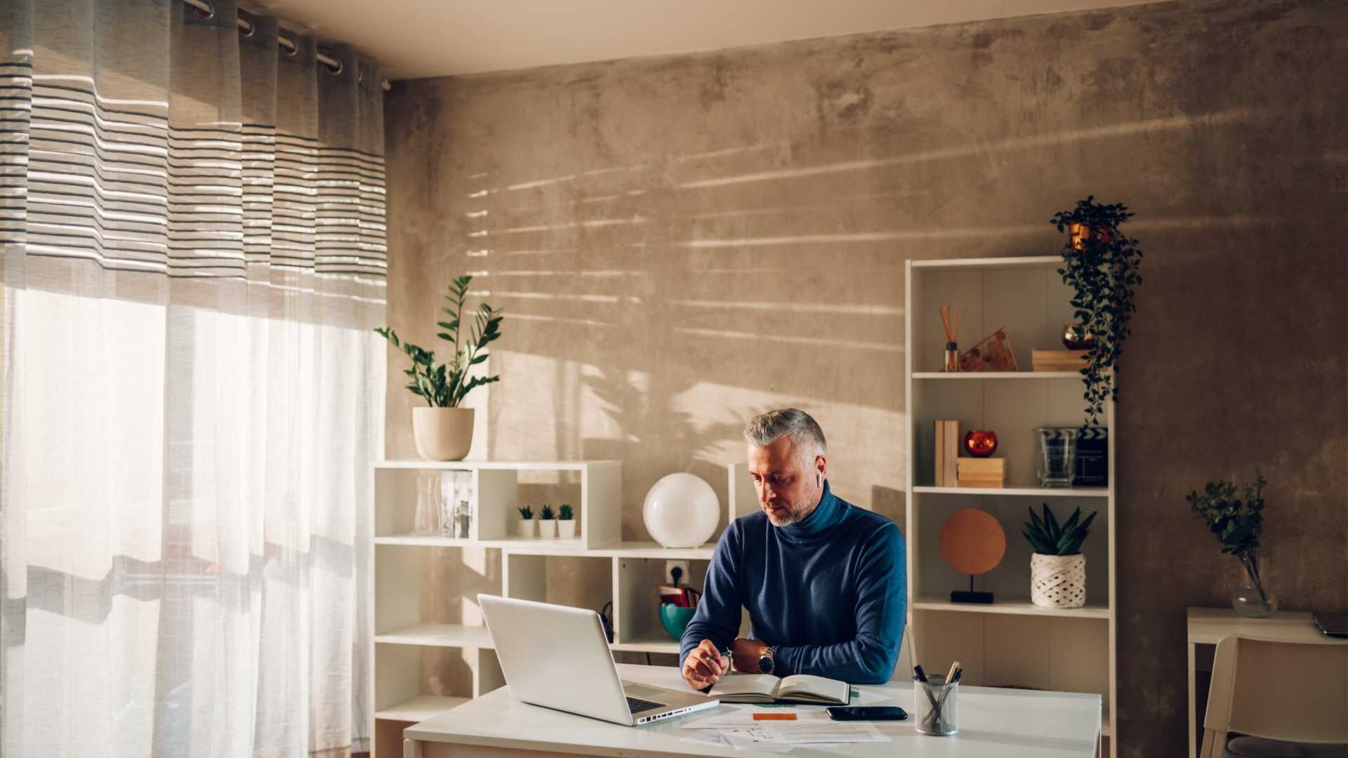 Man working on his computer from his home office