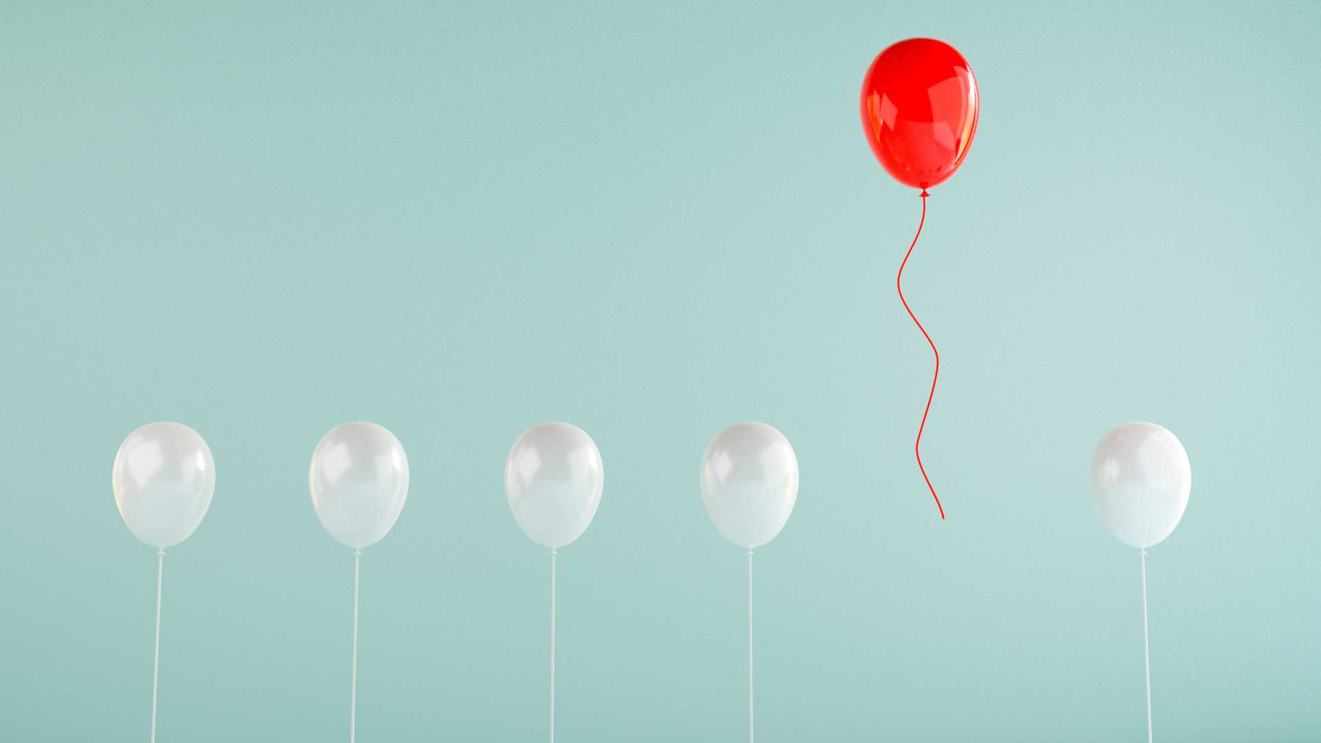 Balloons floating and red balloon is floating higher