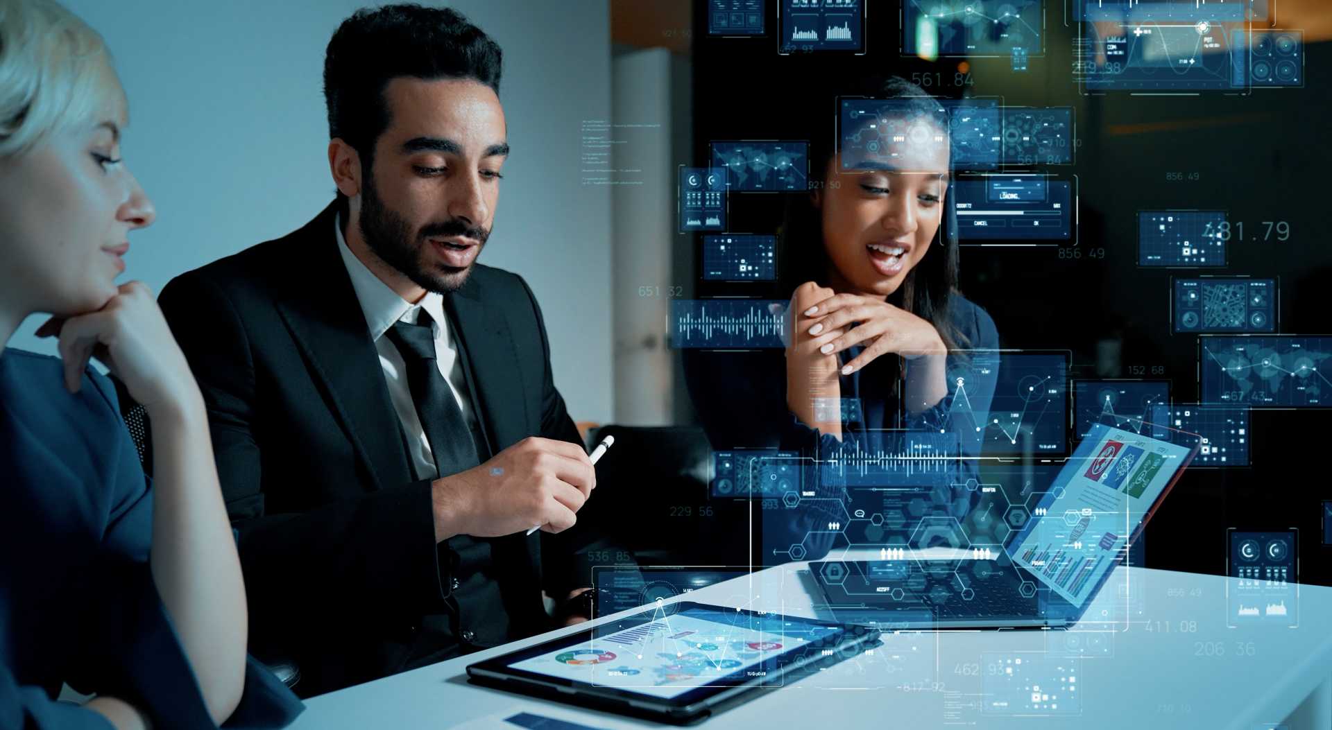 People looking at a computer screen at graphs