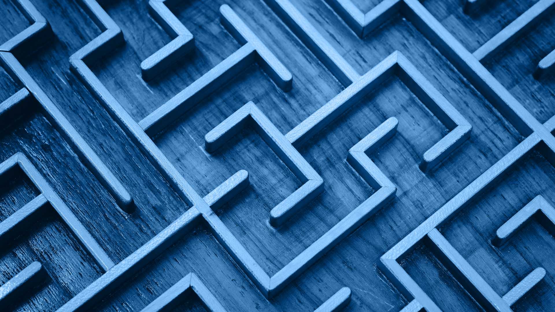 Close up of blue toned wooden labyrinth maze, elevated high angle view
