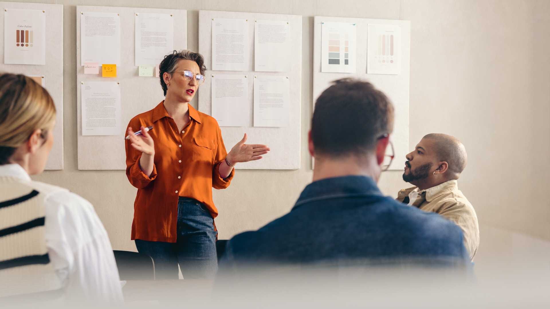 Woman pitching something to her team
