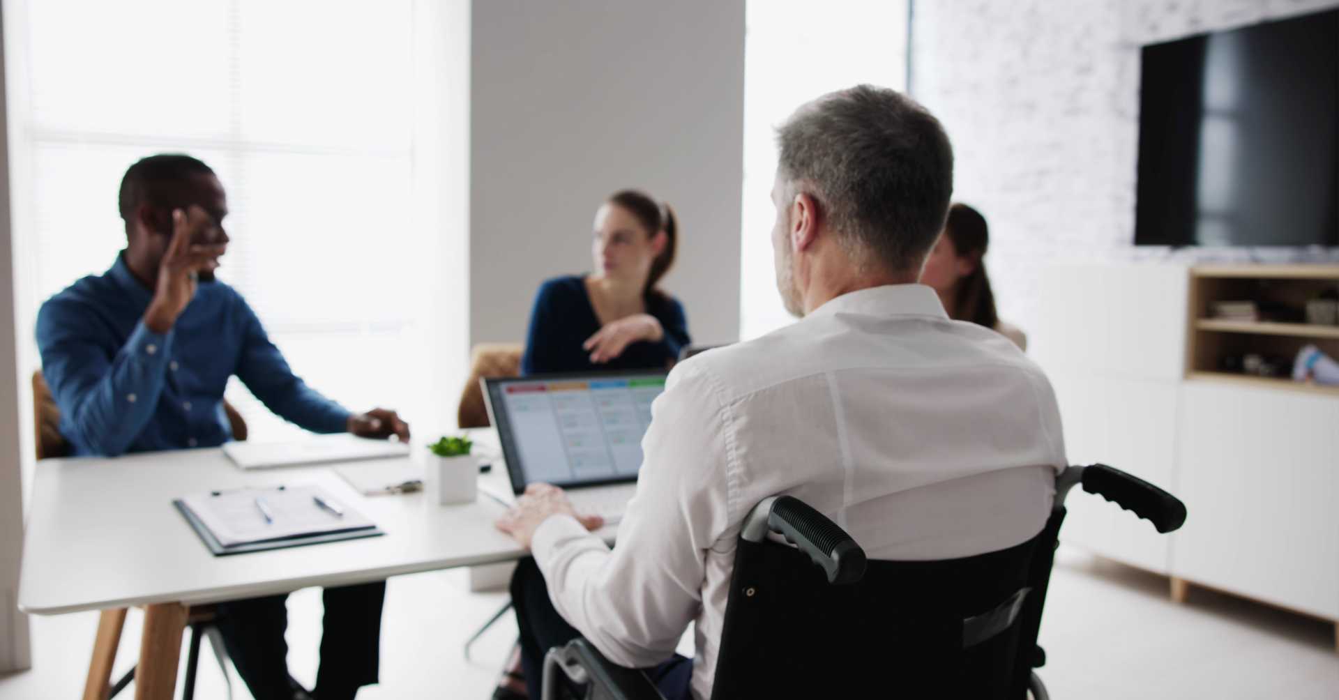 A group of people sitting together in a conference room and discussing something