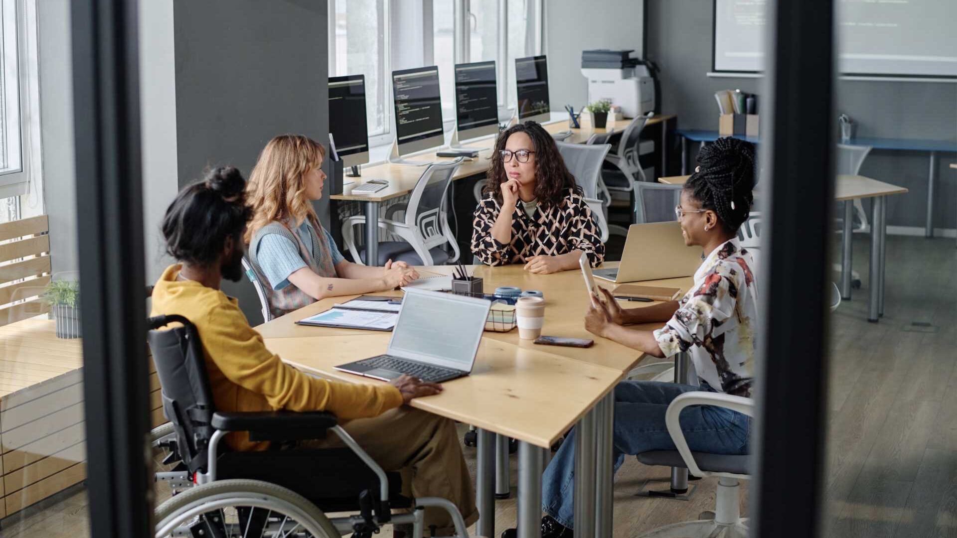 Group of people sitting together in a conference room discussing a business tatic