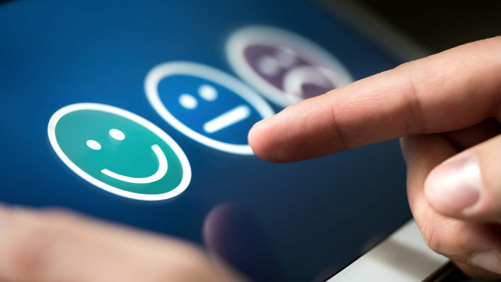 user experience or customer satisfaction research. Quality control and feedback concept. Man choosing his opinion with smiley faces on touch screen.