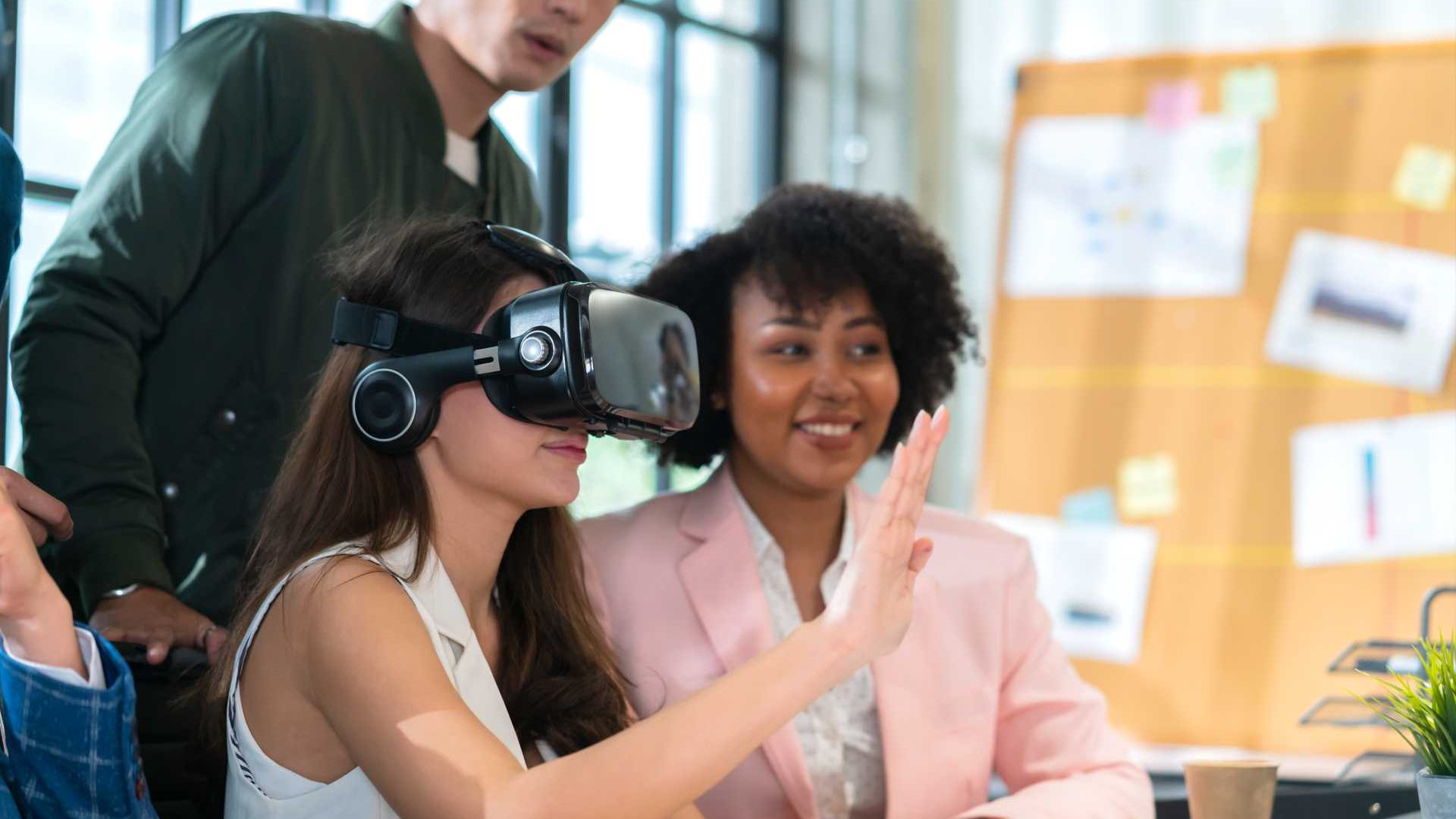 People in office using VR headsets for training.