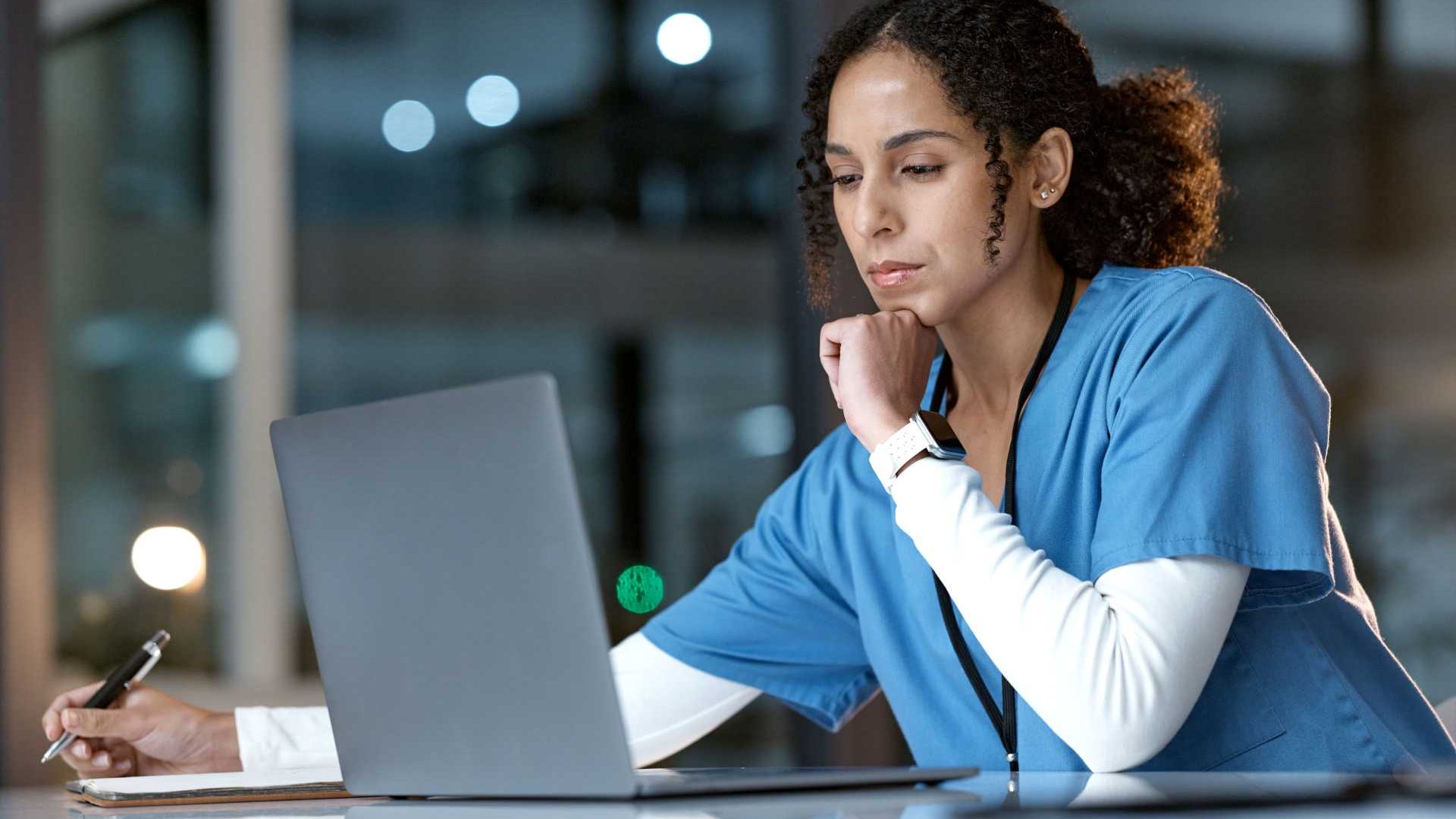 Healthcare nurse looking at the computer.