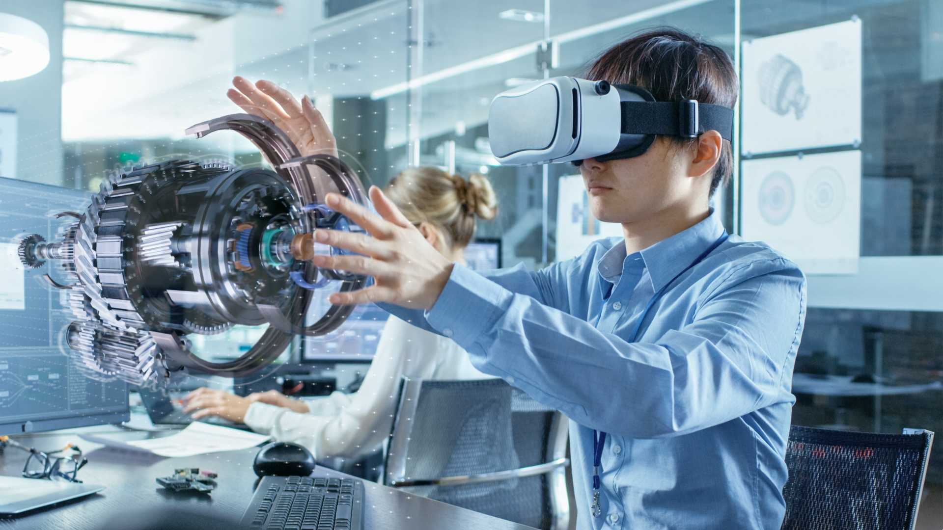 Man using Edtech while wearing VR googles to complete a project.