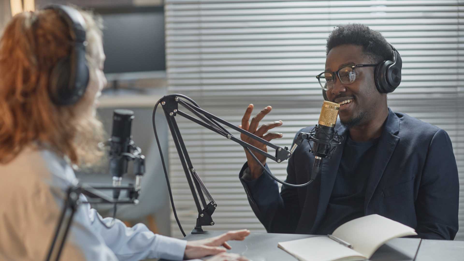 Podcasters recording an episode together engaging curating content for marketing.