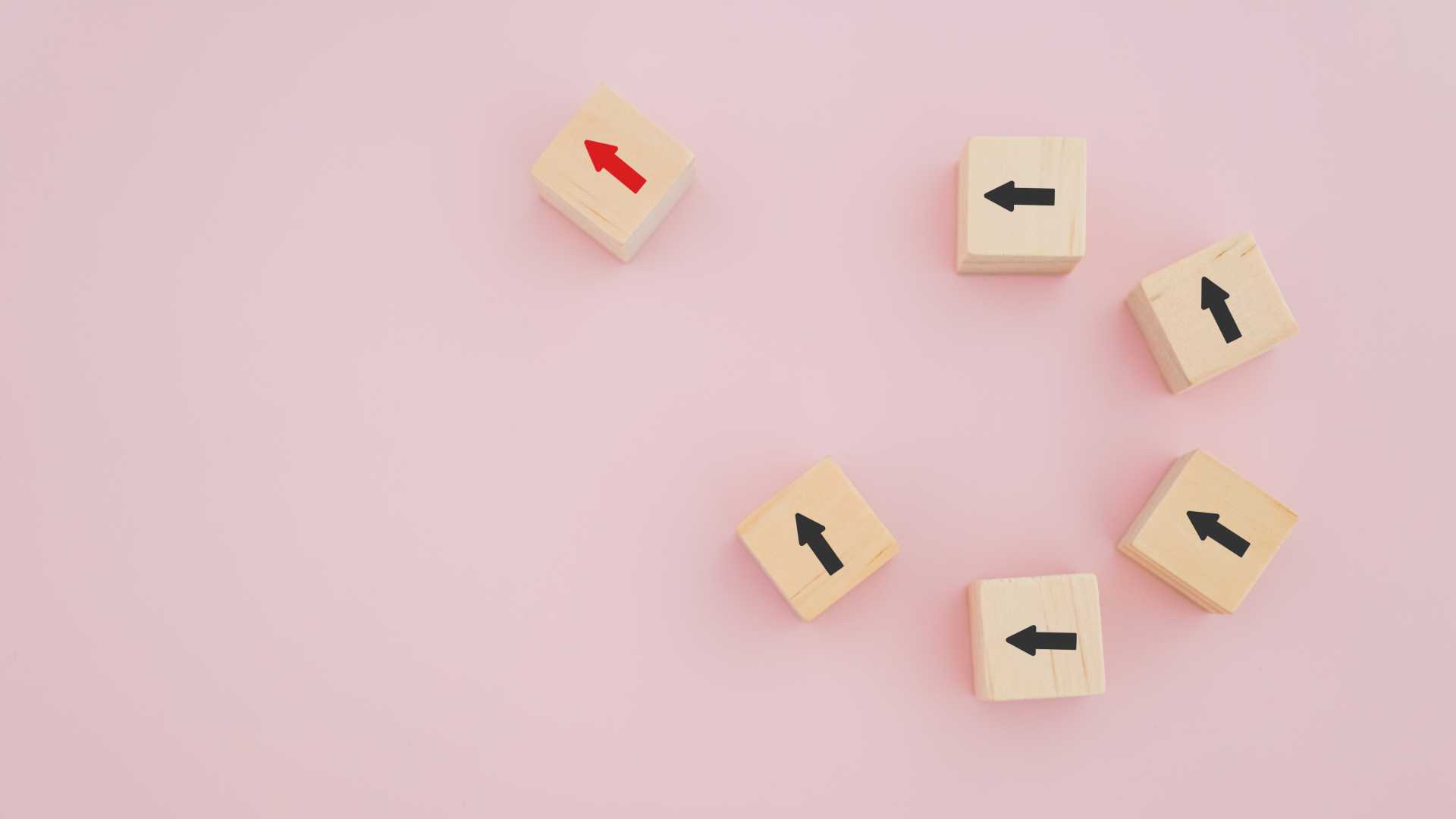 Pink background with blocks of black arrows point up toward a red arrow