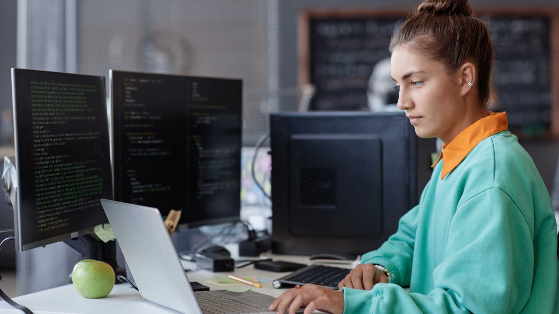 A woman working at her desk on a laptop