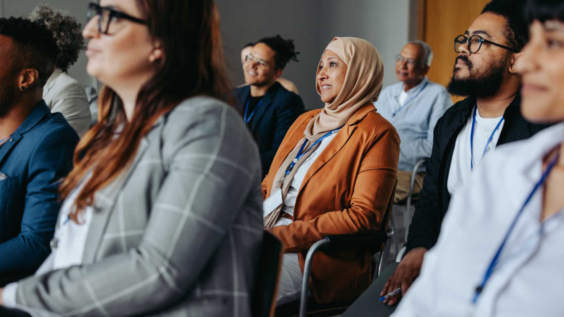 A group of diverse individuals viewing a presentation.