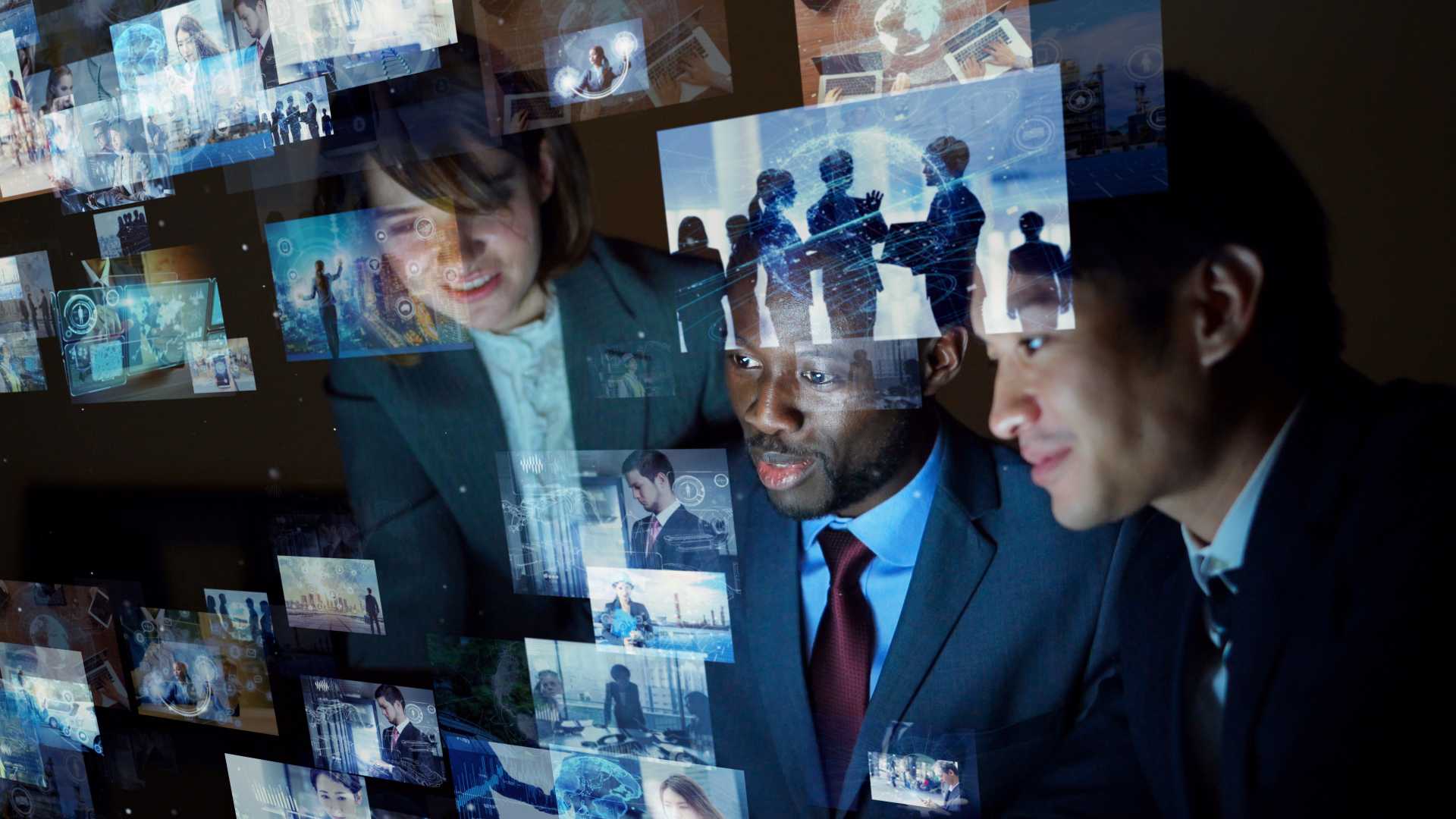 Team of people looking at digital graphics.