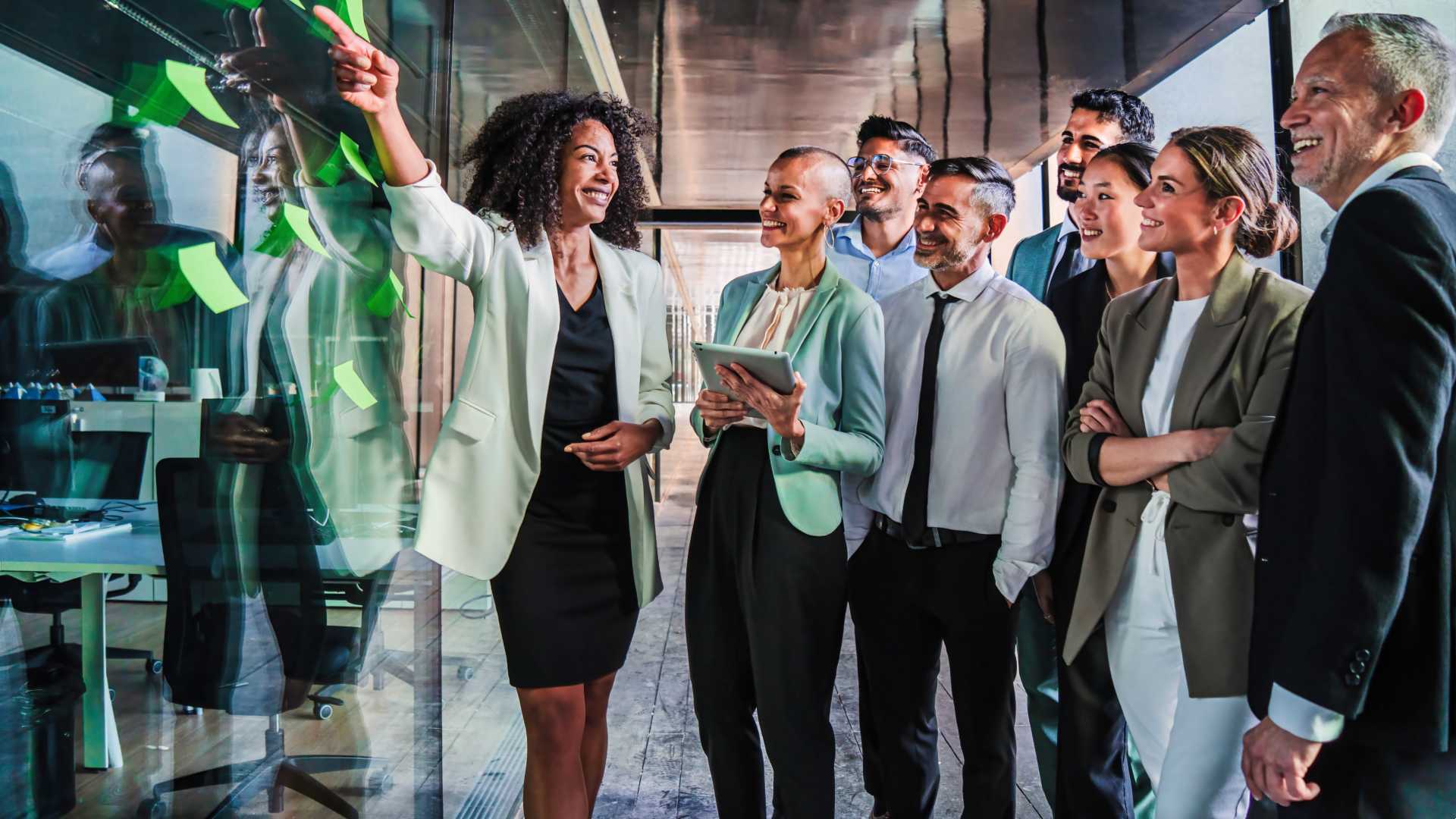 Woman showing her coworkers a board with a plan for aligning L&D with business goals.