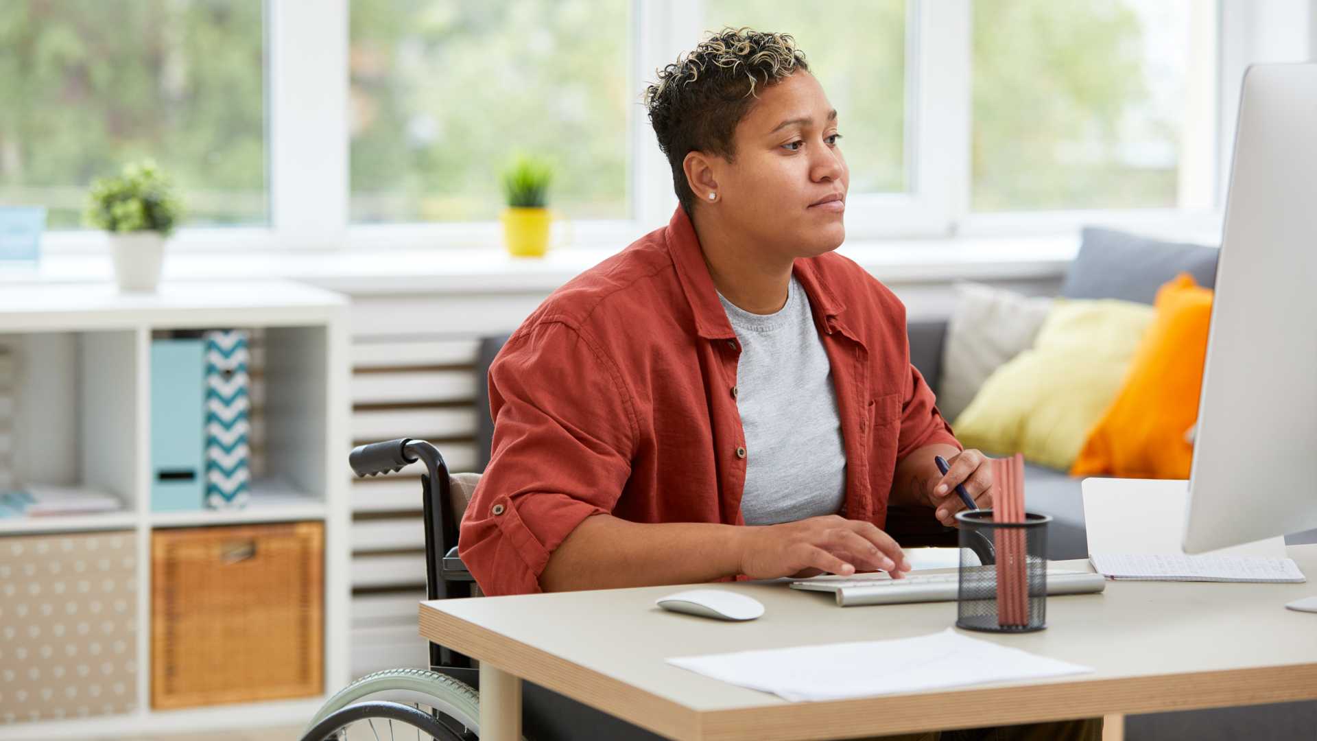 Woman looking at her computer doing work.