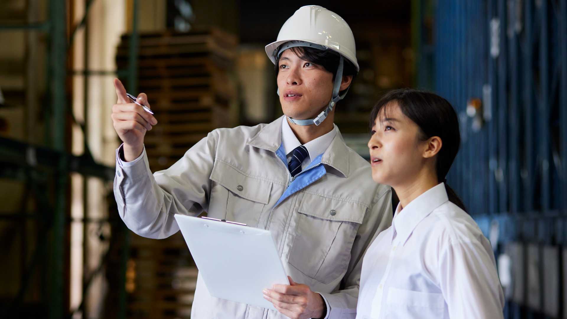Two front-line workers observing a project together.