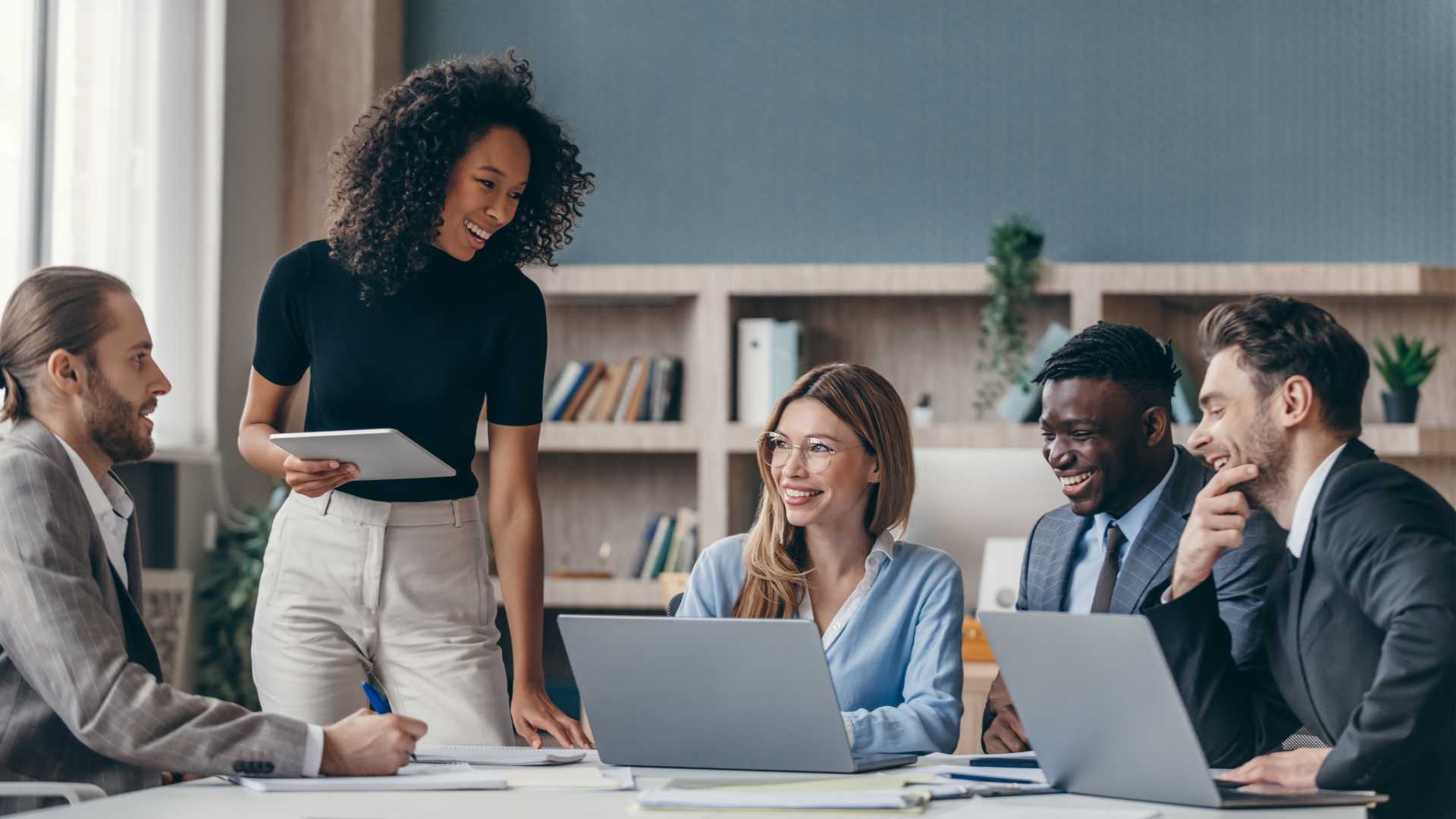 Team of people working together in a meeting.