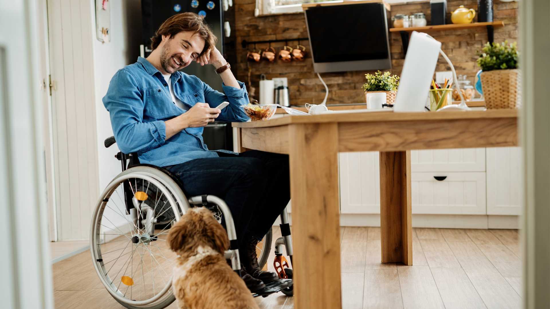 Man in a wheelchair taking a break with his dog.