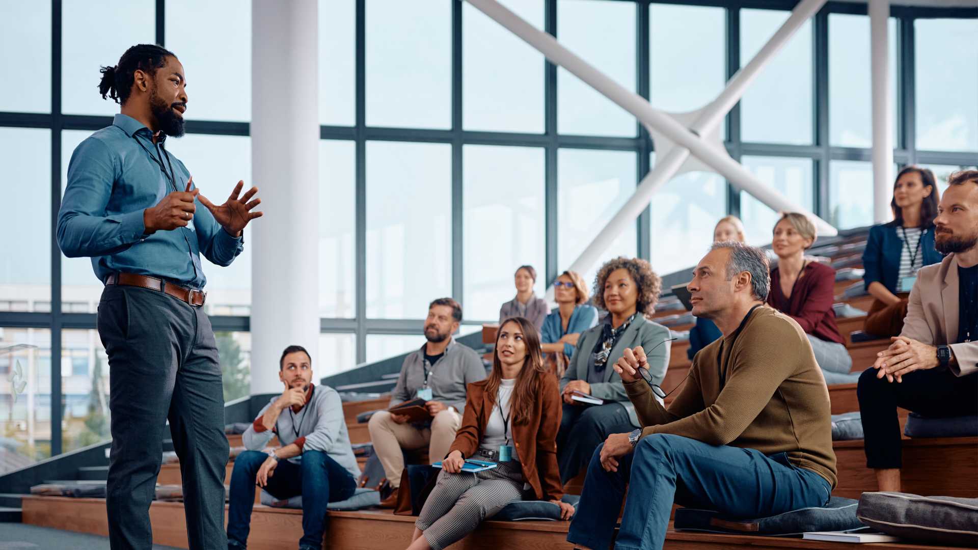 A man speaking to a crowd of people.