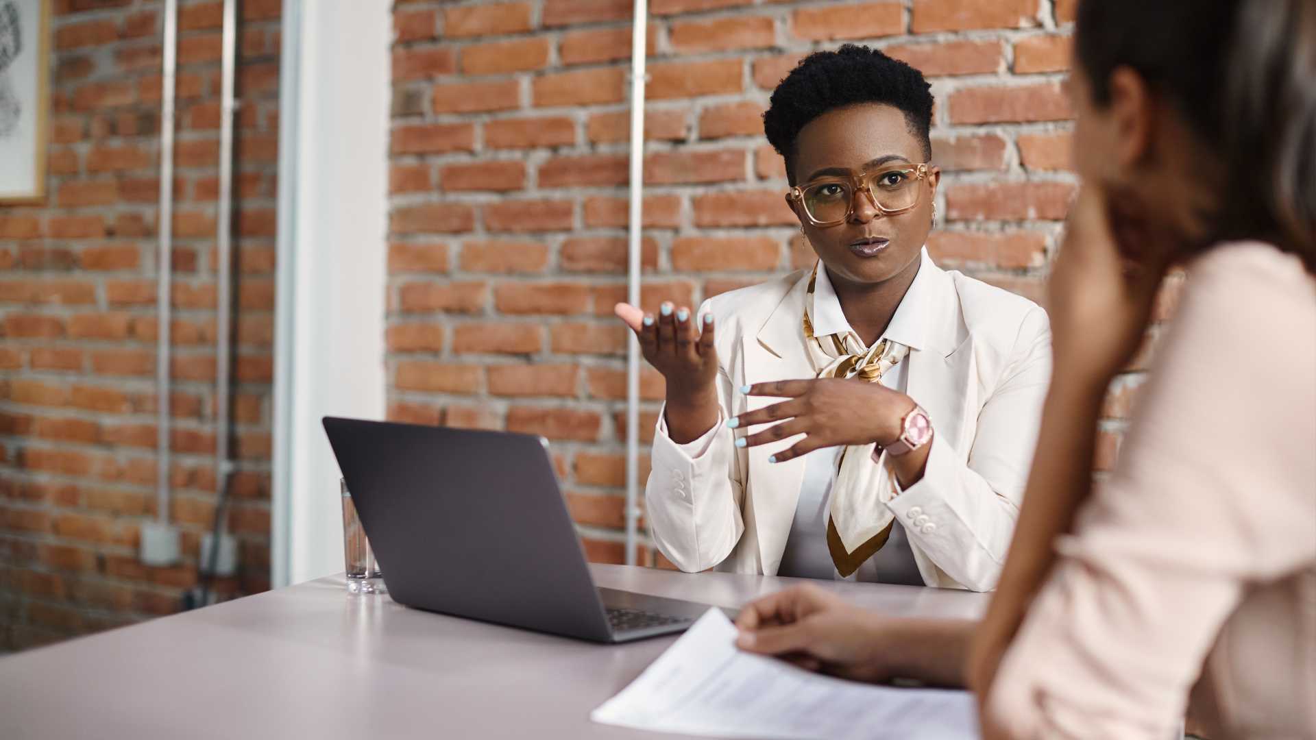 Company leader demonstrating human-centered leadership skills with colleague and/or employee.
