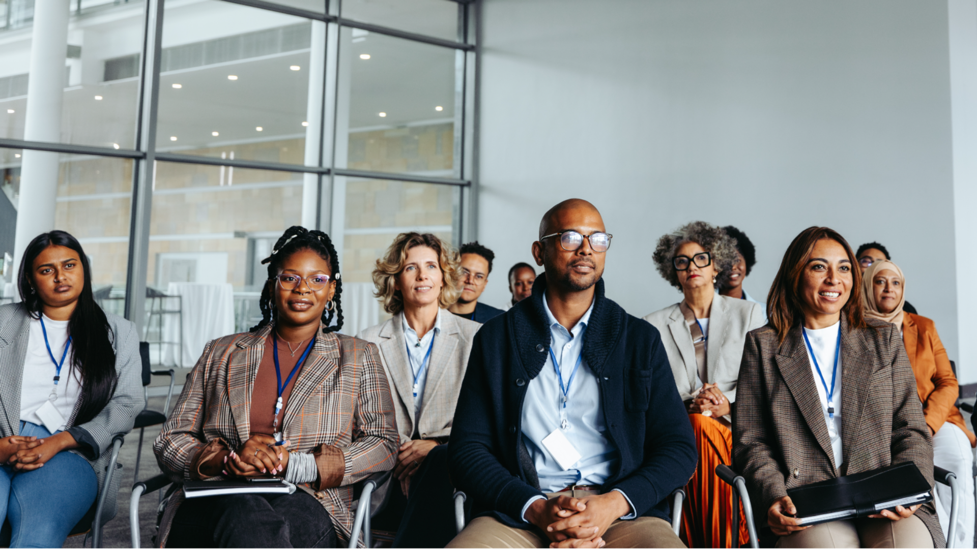 A group of people sitting in a presentation