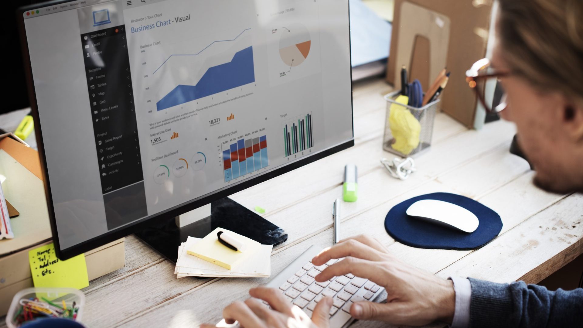 Woman looking at graphs in office.