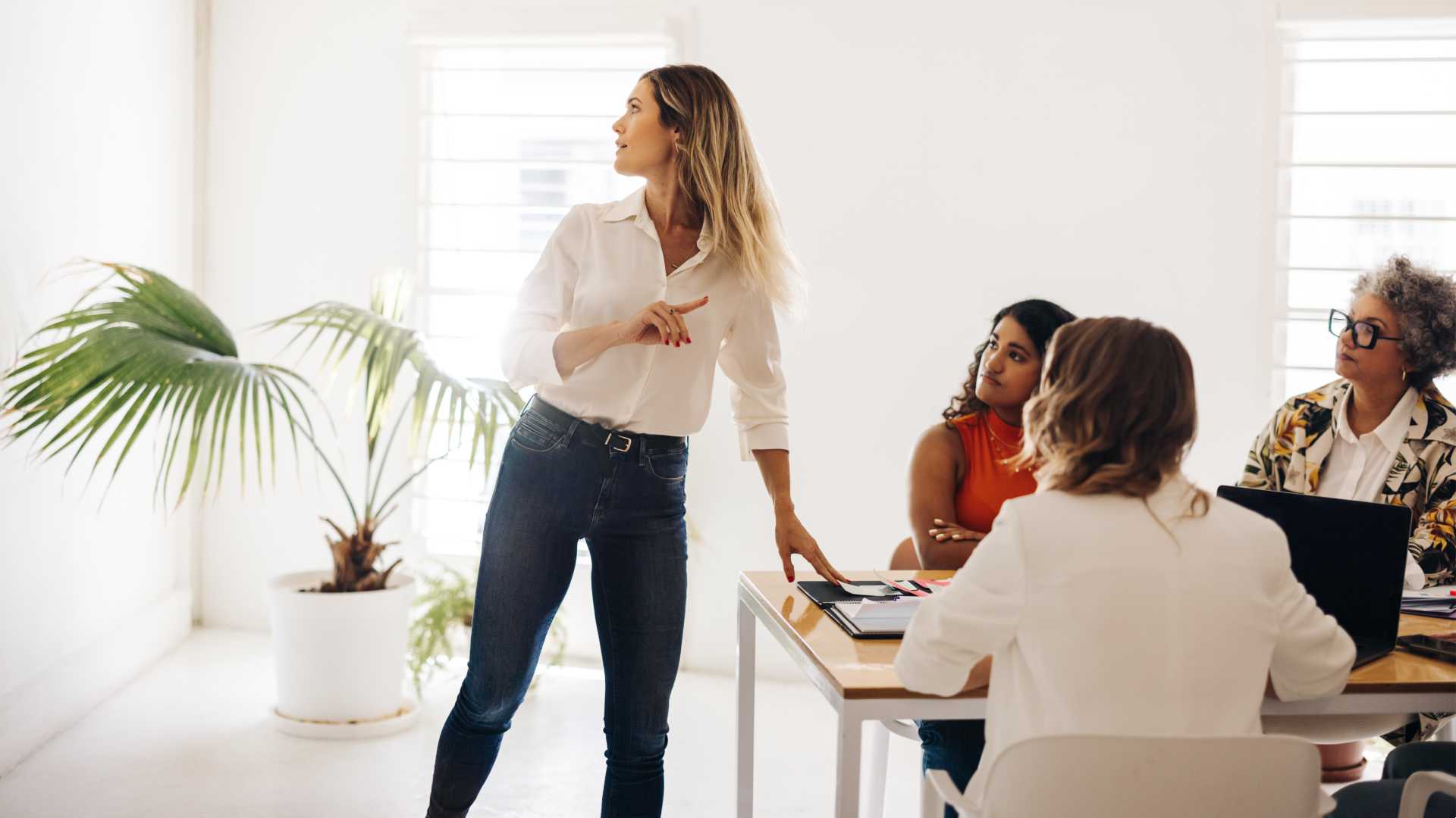 Group of businesspeople in an office setting collaborating.