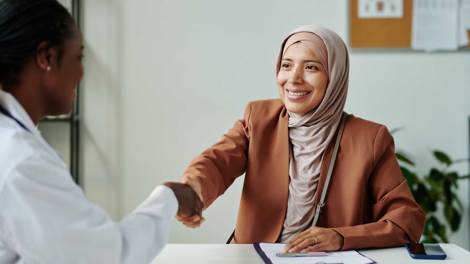 Woman shaking hands with her coworker.