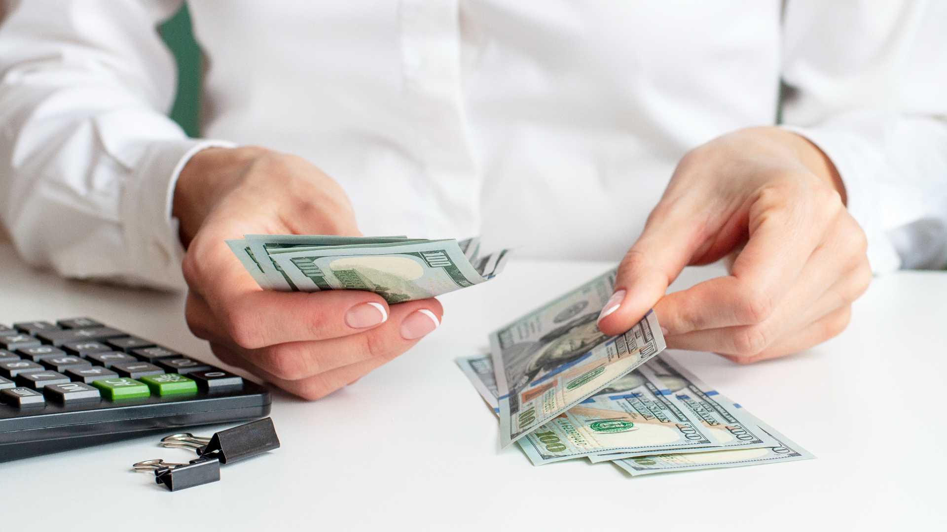 Woman counting money at her job.