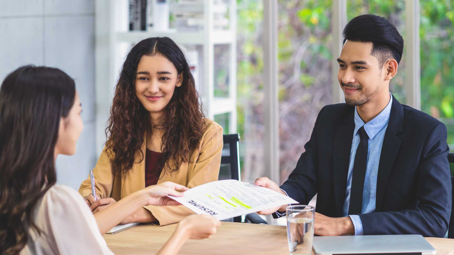 man reviewing documents with his coworkers.