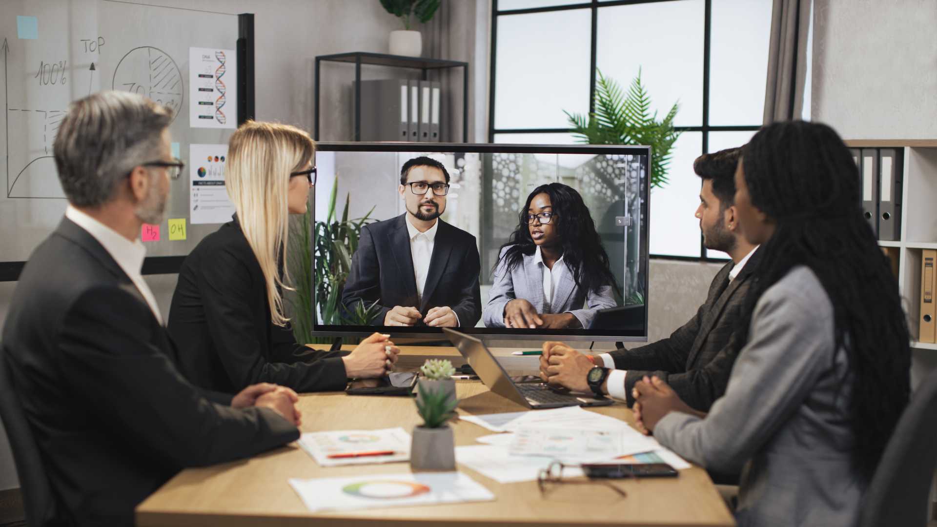 Group of co-workers together discussing a certain topic on a presentation.