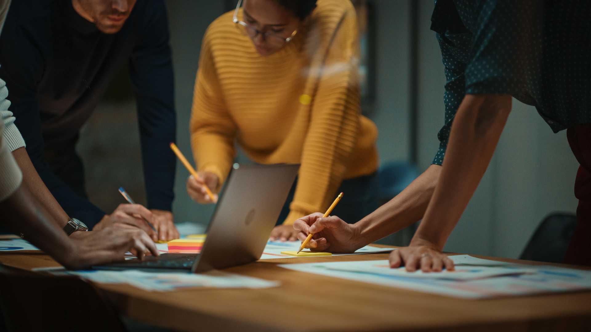 Woman working together with her coworkers on a project.
