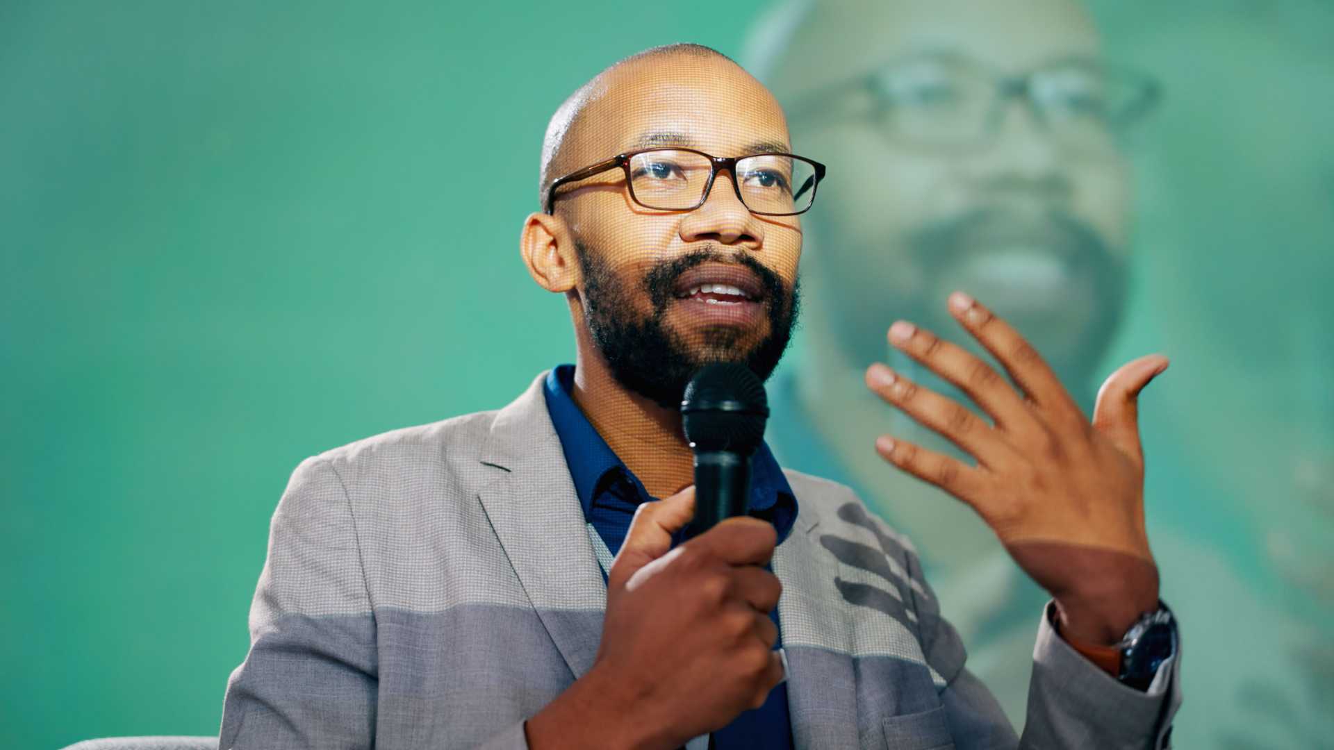 Man speaking on something.