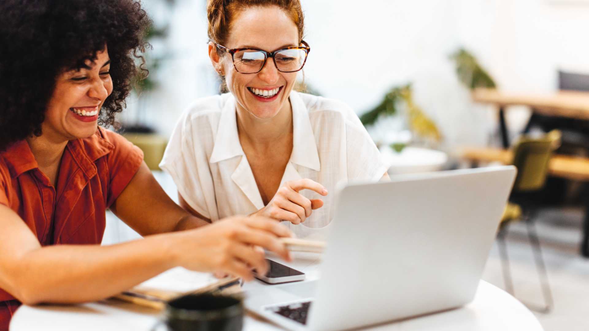 Woman helping her coworker with a task.