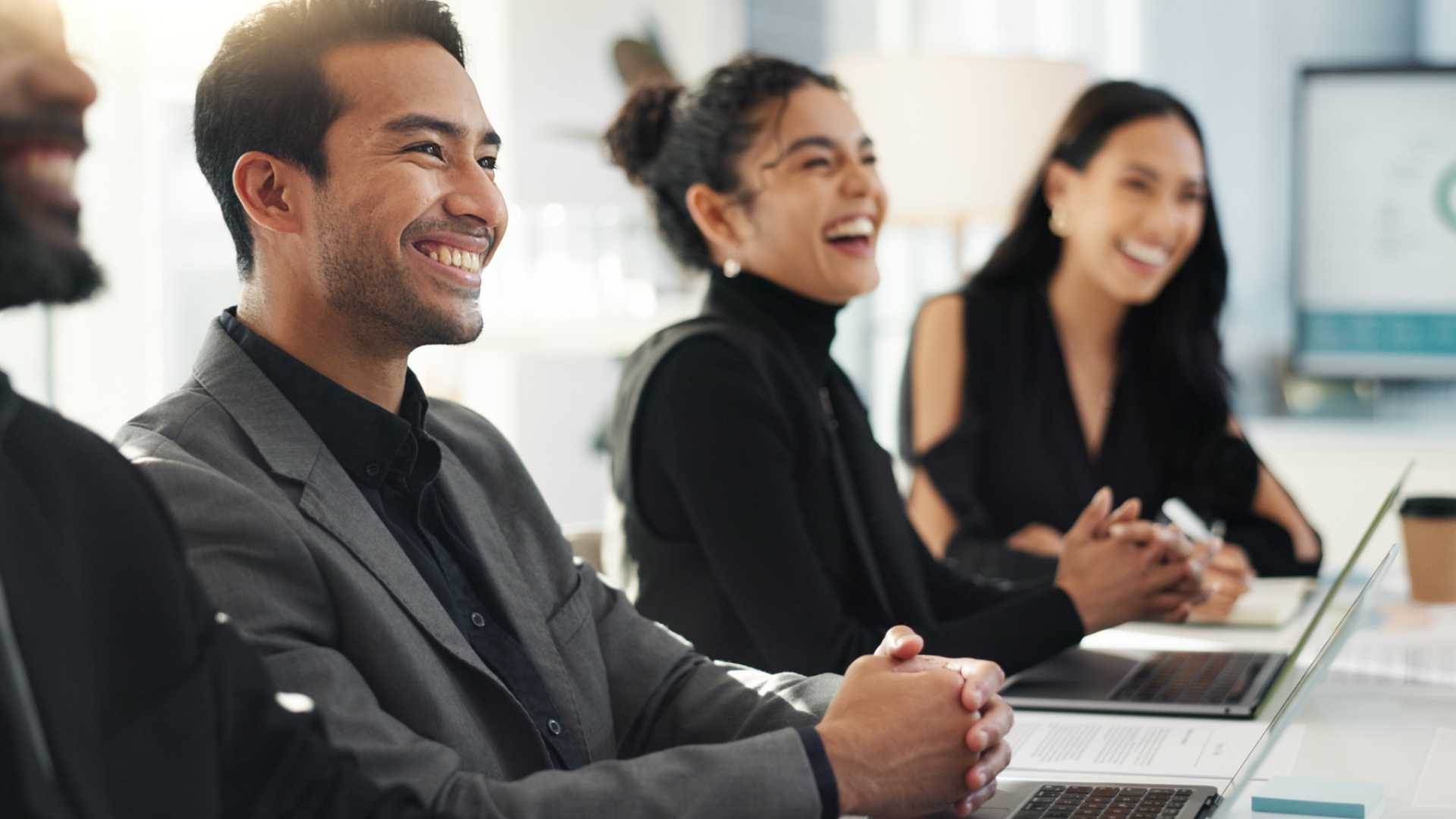 A group of people together in a meeting.