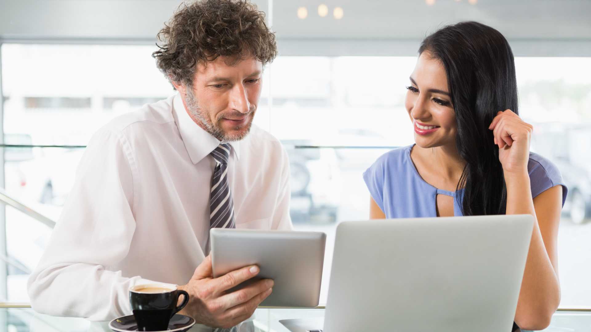 Man and woman looking at work together for a project.
