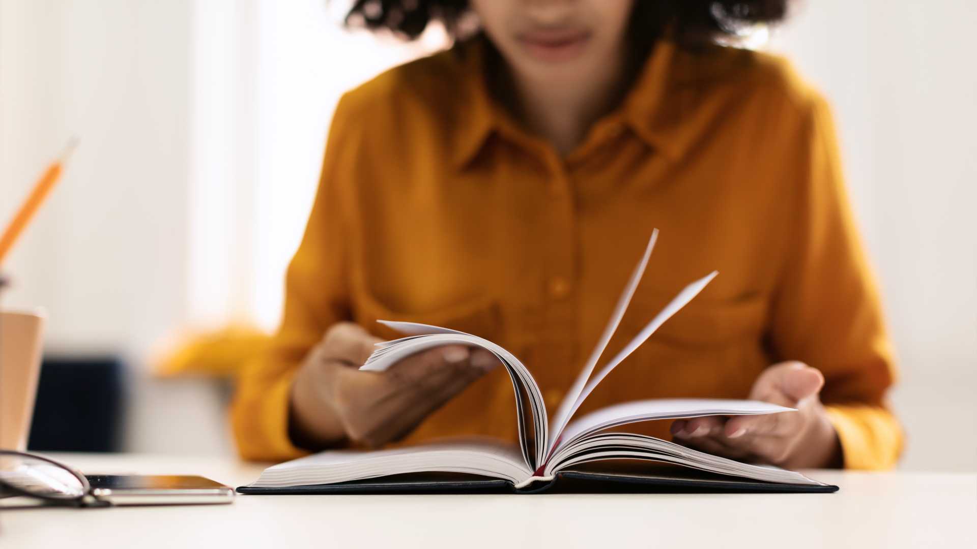 Woman looking through a book.