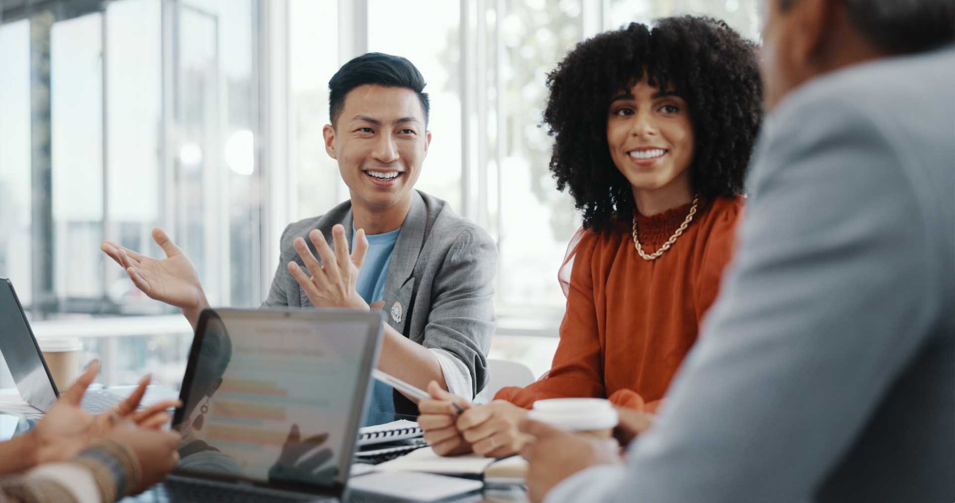 Office workers collaborating while seated at a conference room table