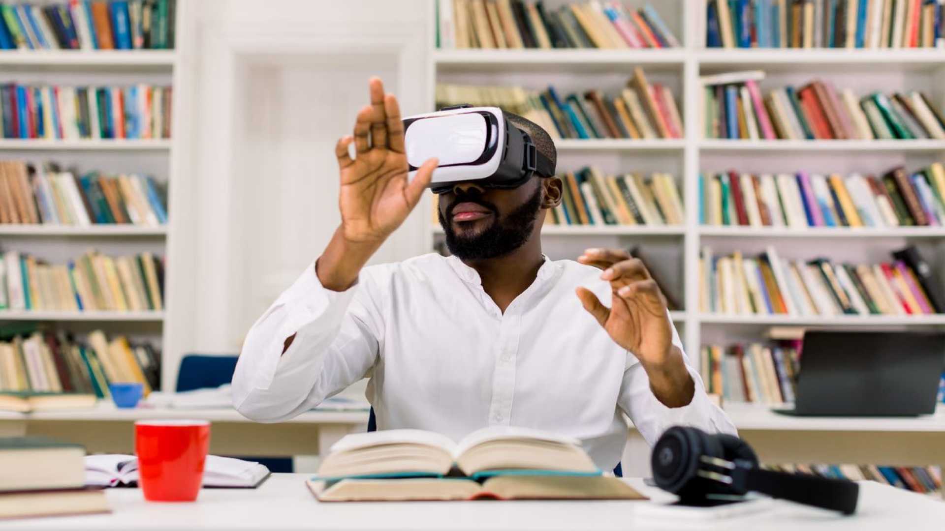 Man wearing VR googles doing work.