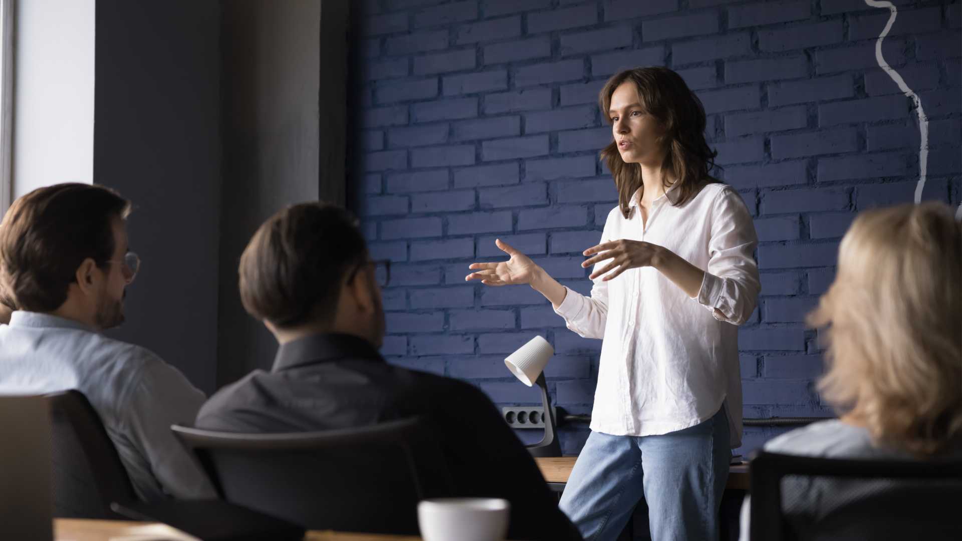 Woman giving a team meeting to her collagues.