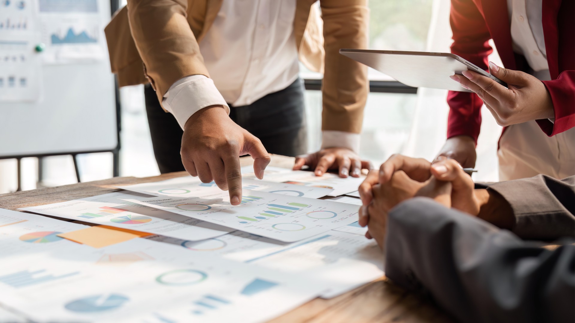 Business team looking over charts and graphs.