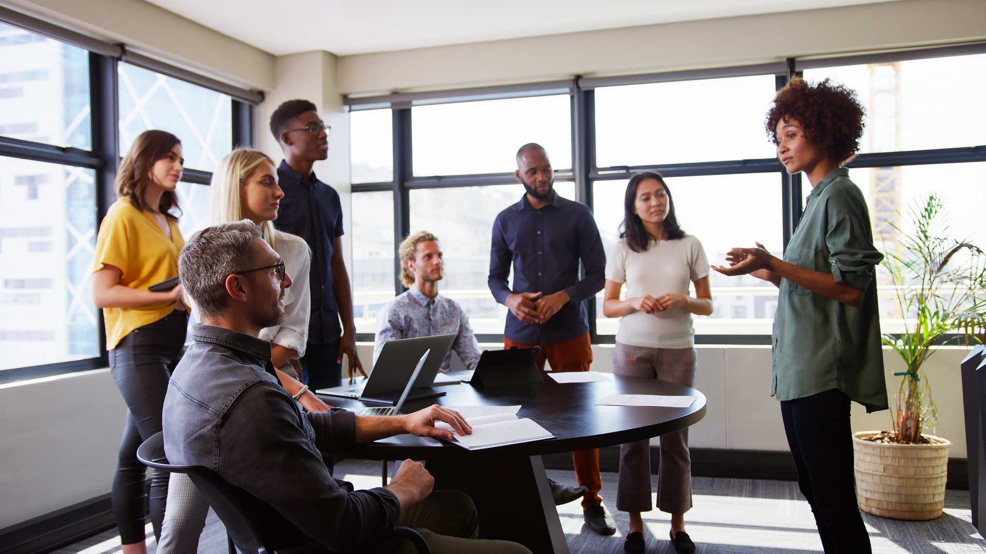 A diverse team meeting with technology.