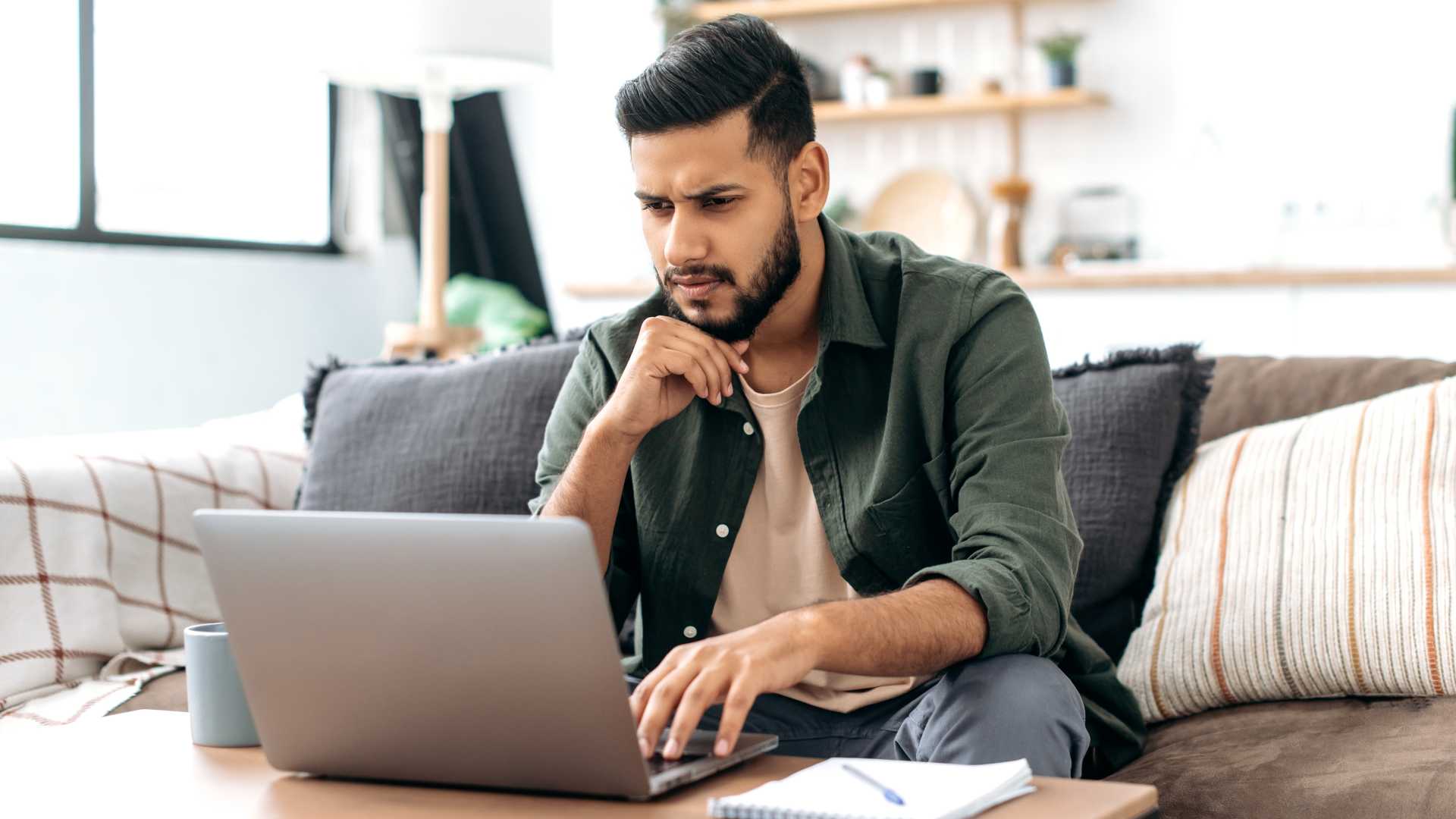 Man looking confused at his work computer.