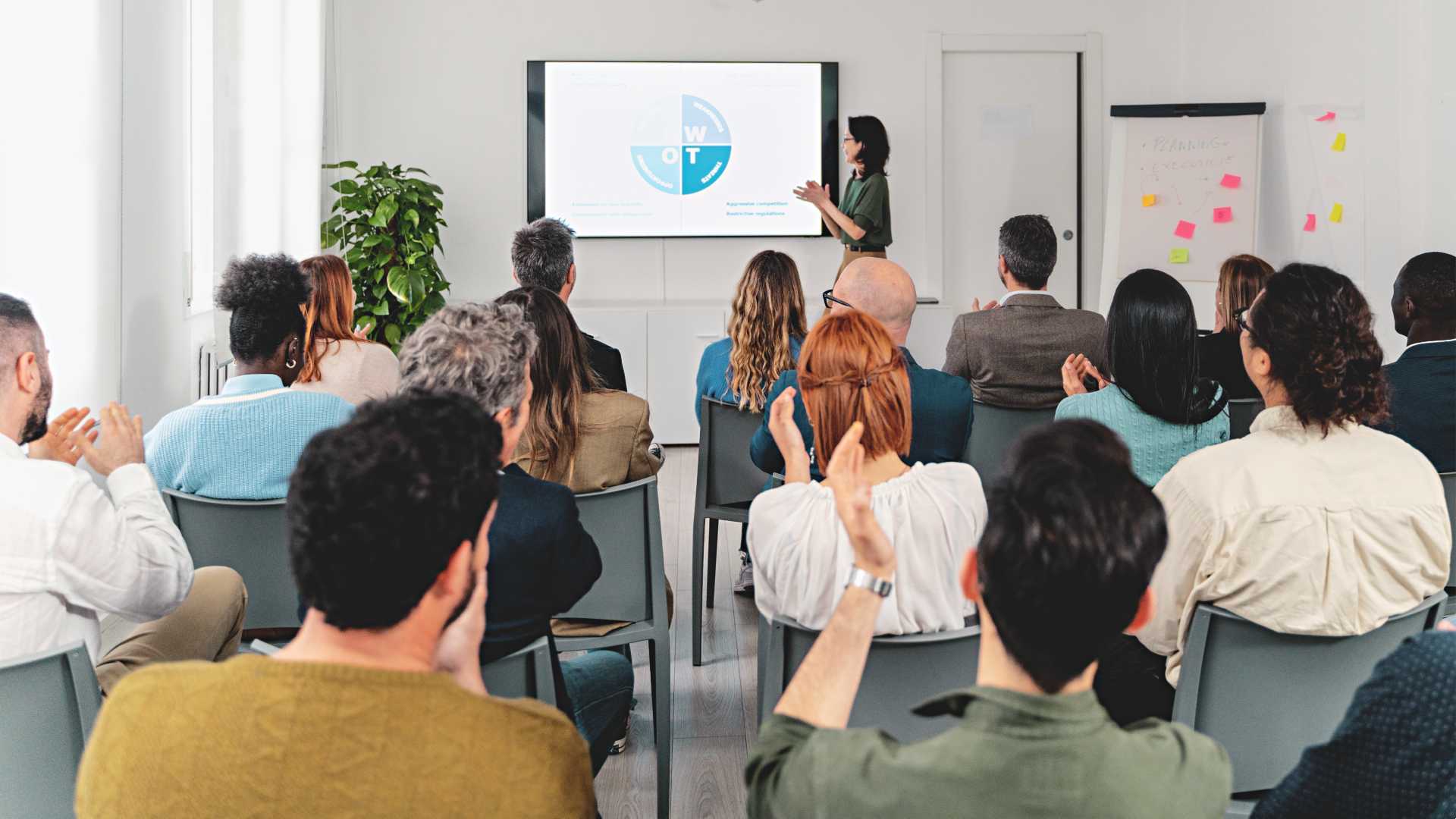 Woman giving a presentation to a group of people.