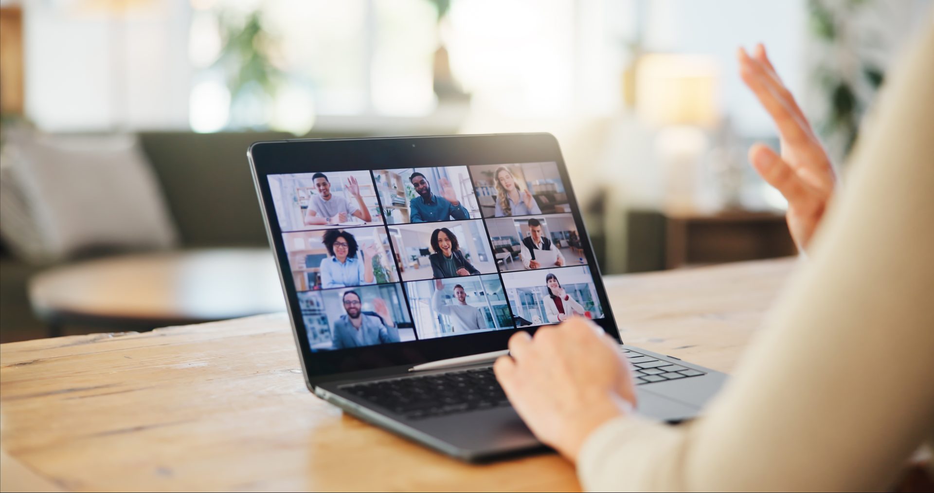 A woman on video call with her coworkers.