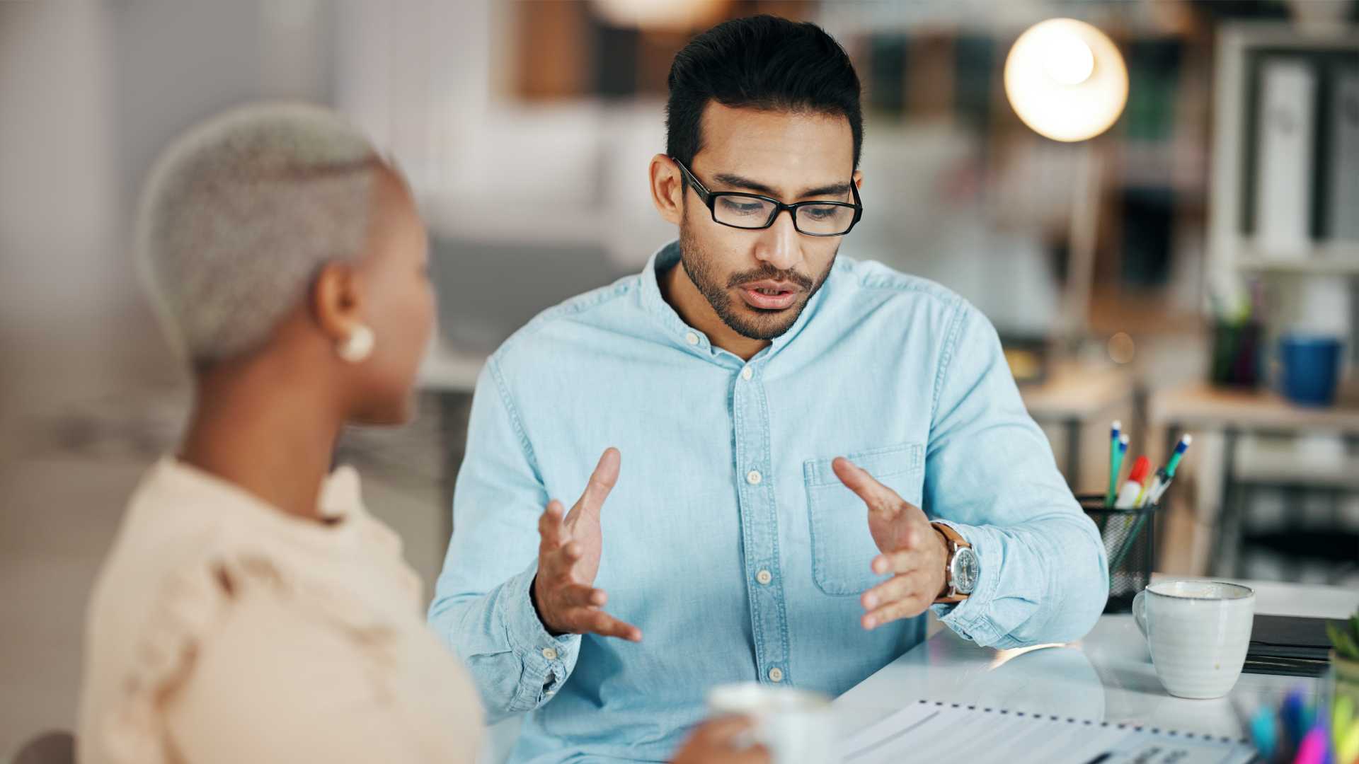 Man discussing something to his coworker.