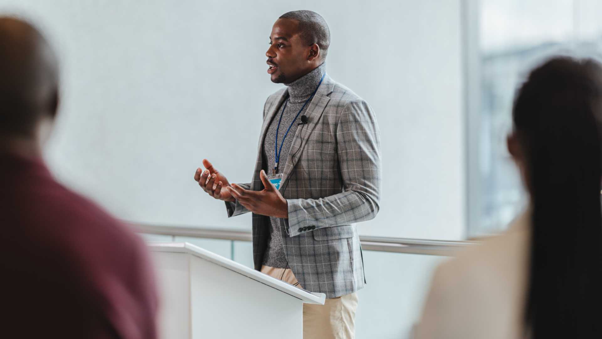 A leader giving a speech to a group of people.