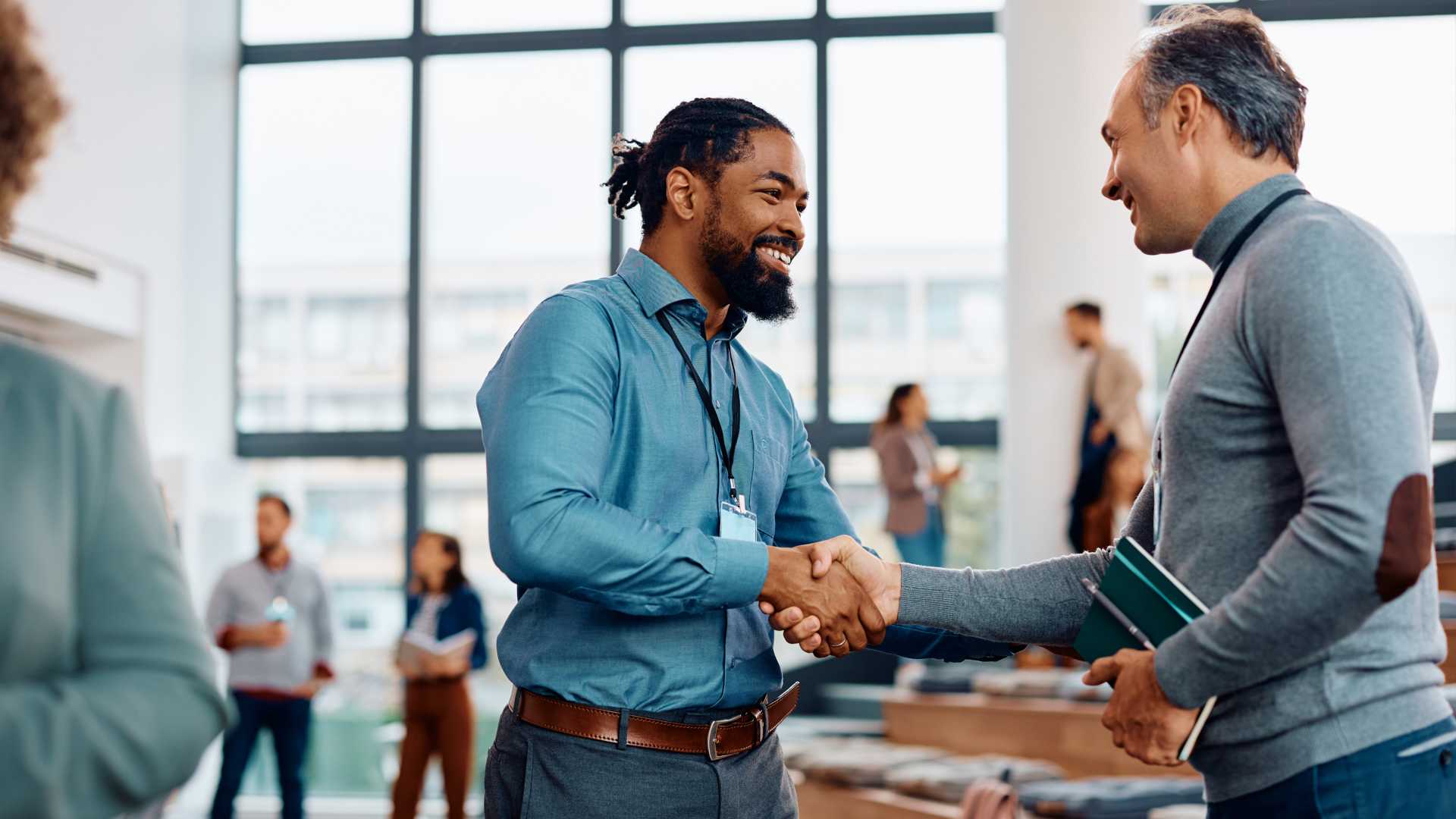 Coworkers shaking hands with a coworker.