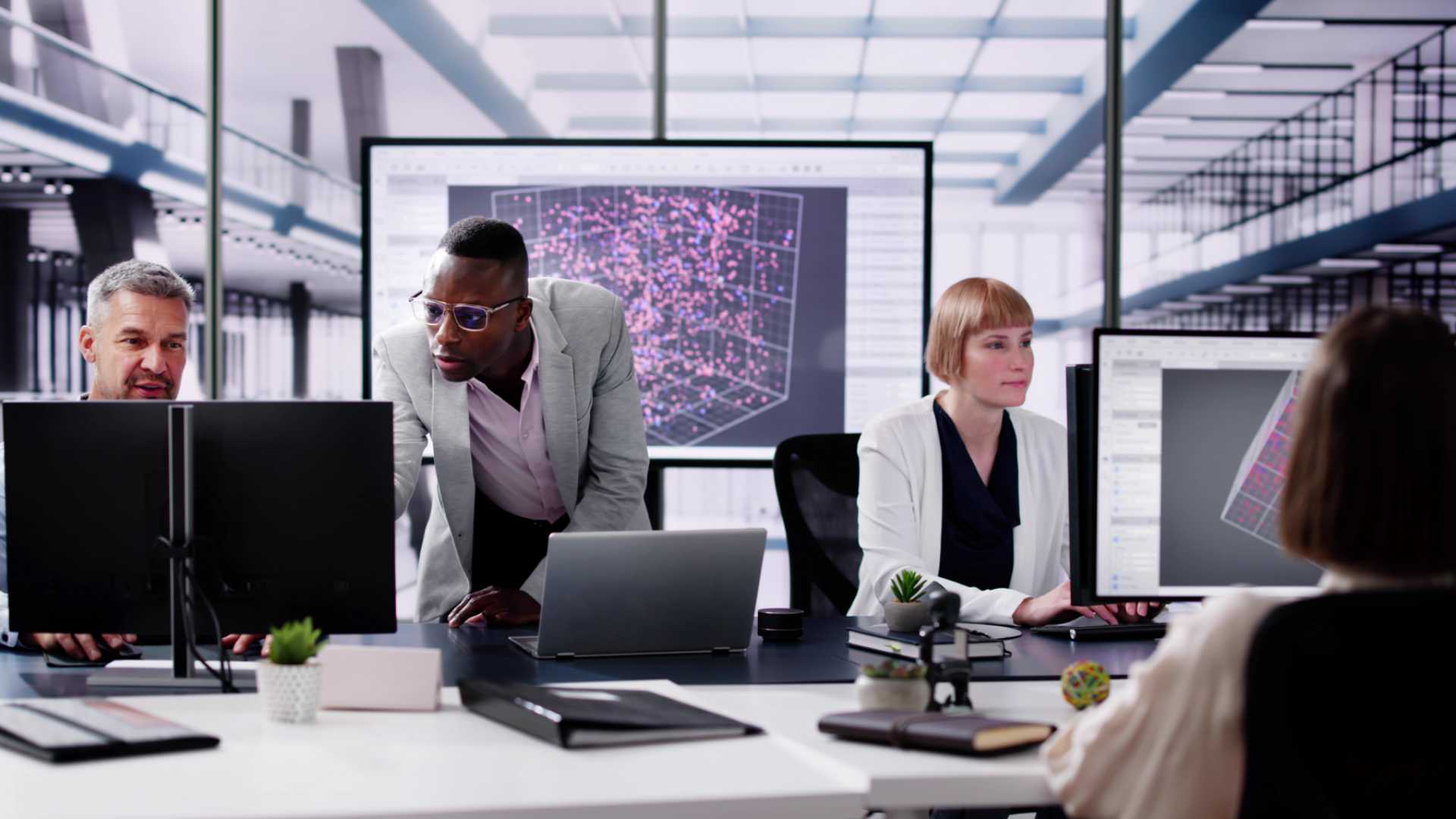 People working on computers in a meeting.